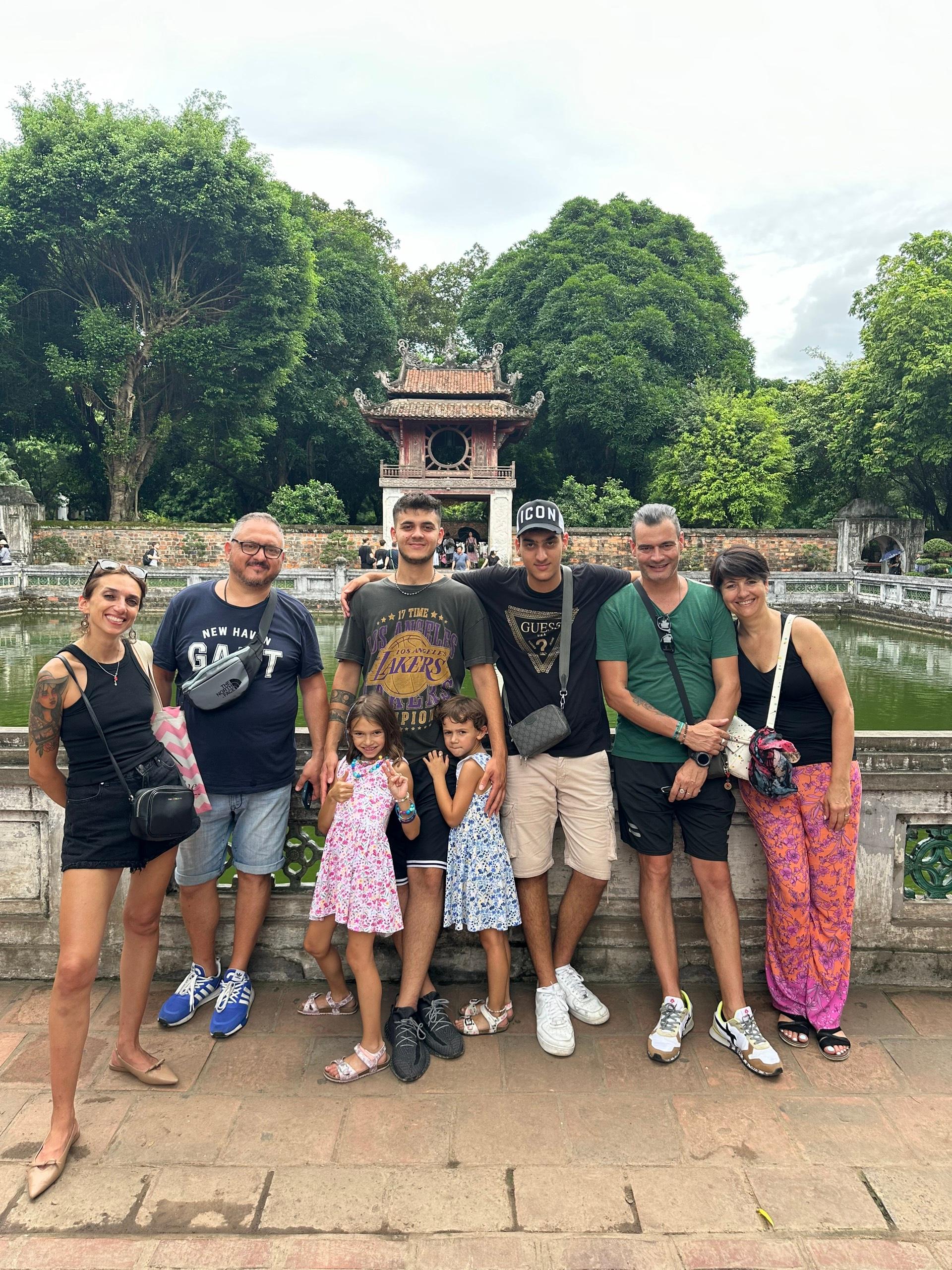 A family group standing together in front of a temple gate