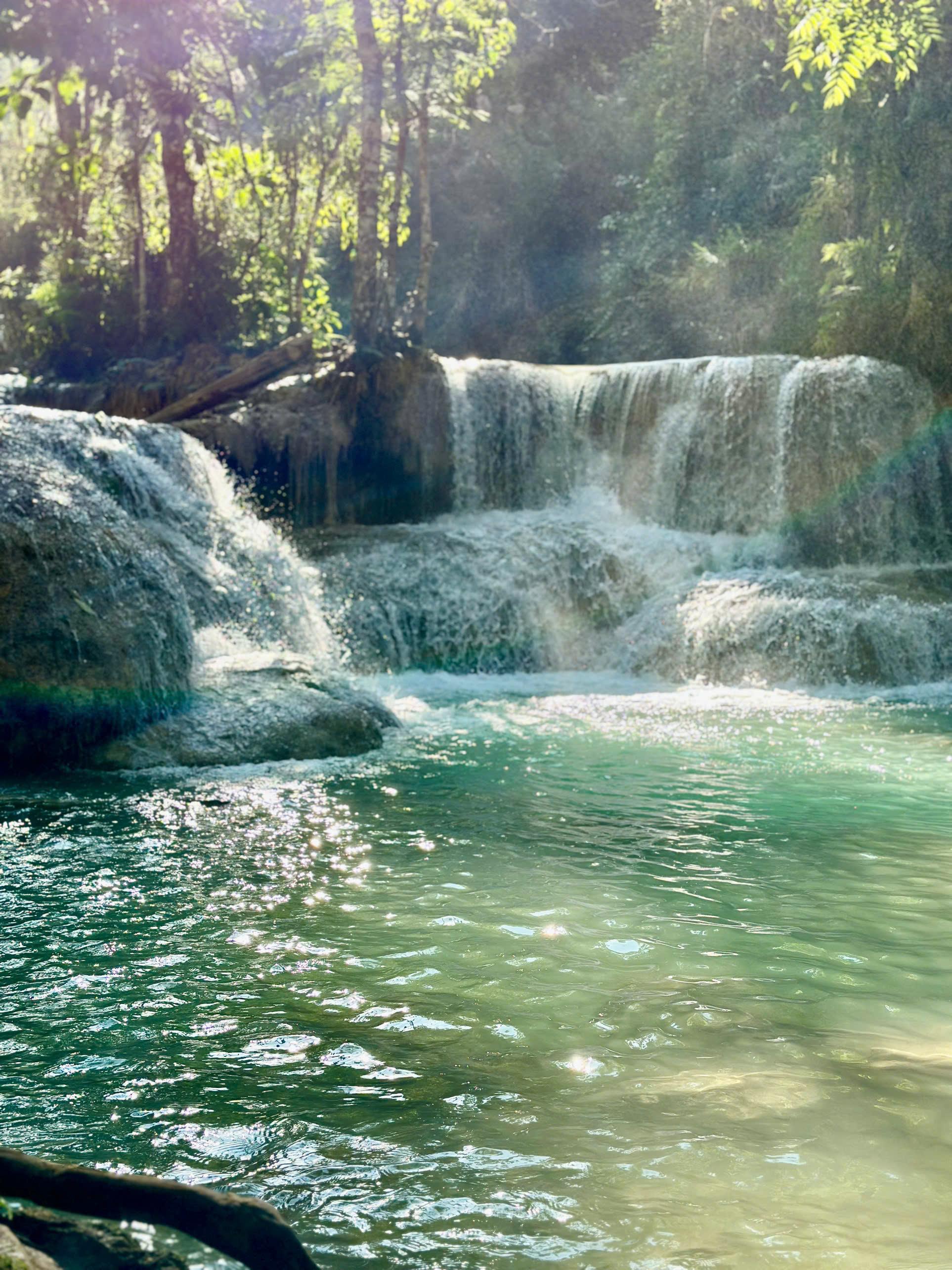 Water spilling over limestone terraces into a turquoise pool