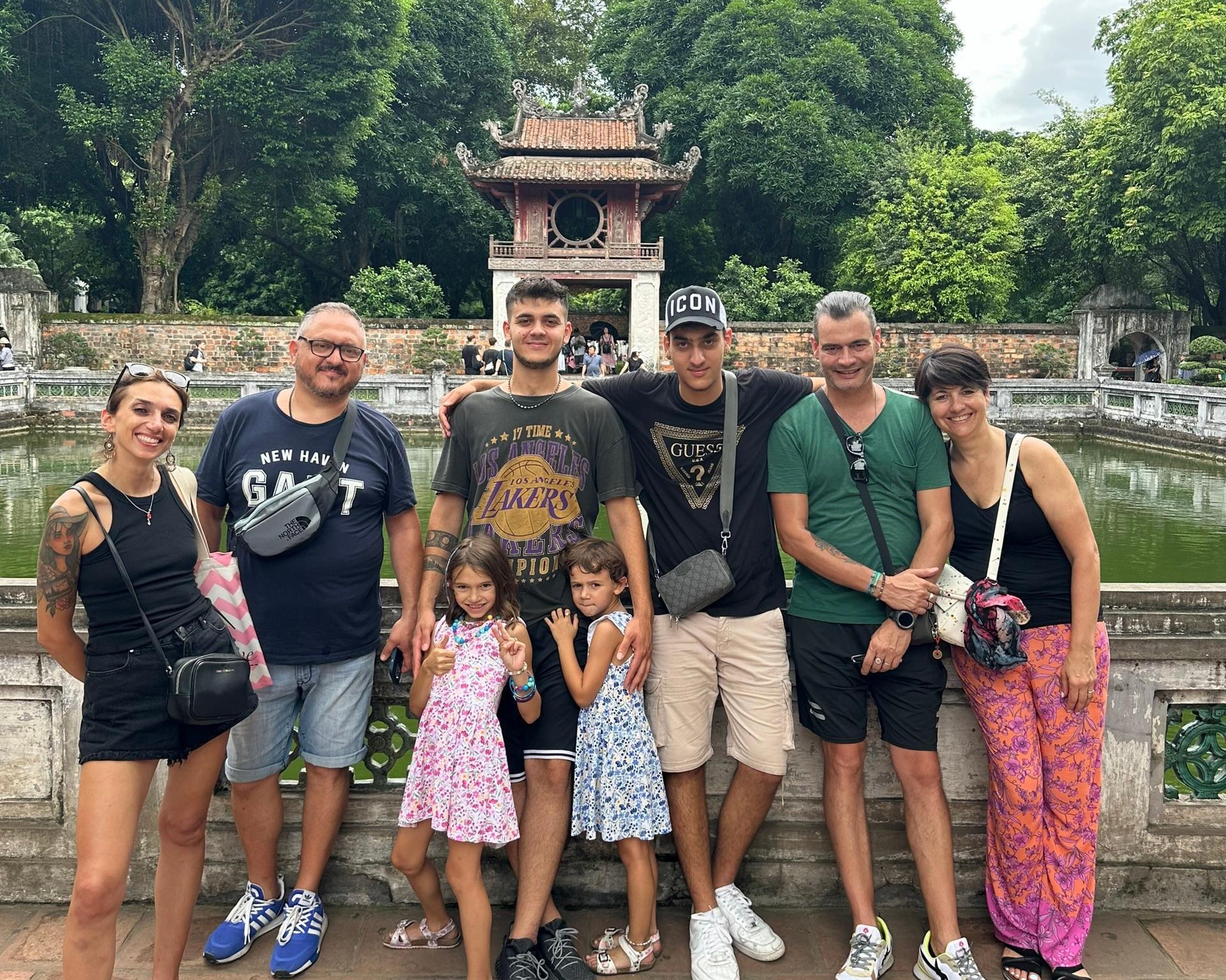Family of travellers in front of a Hanoi temple