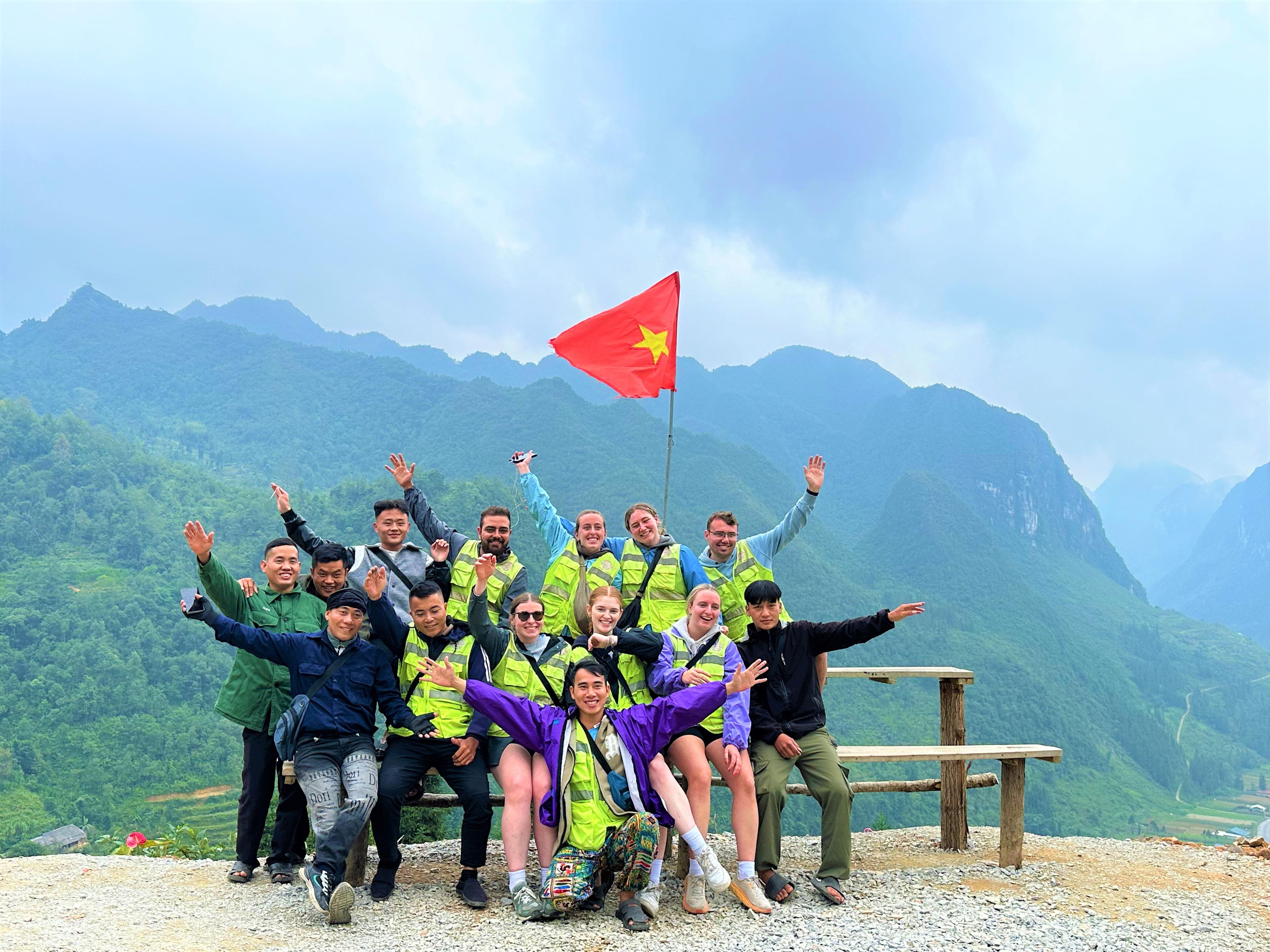 Gruppo con la bandiera vietnamita su un passo di montagna
