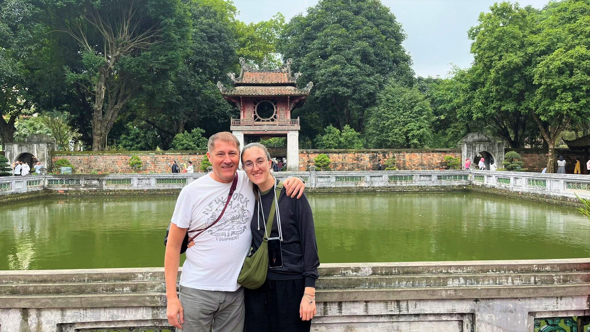 Una coppia davanti al padiglione e al laghetto del Tempio della Letteratura, ad Hanoi